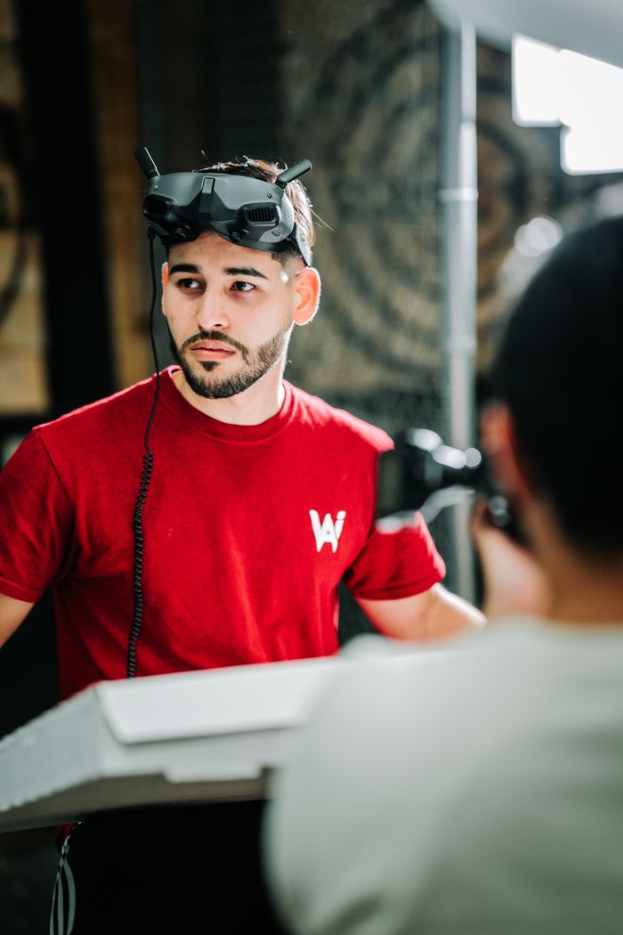 Caucasian man wearing a VR headset during a photoshoot indoors.