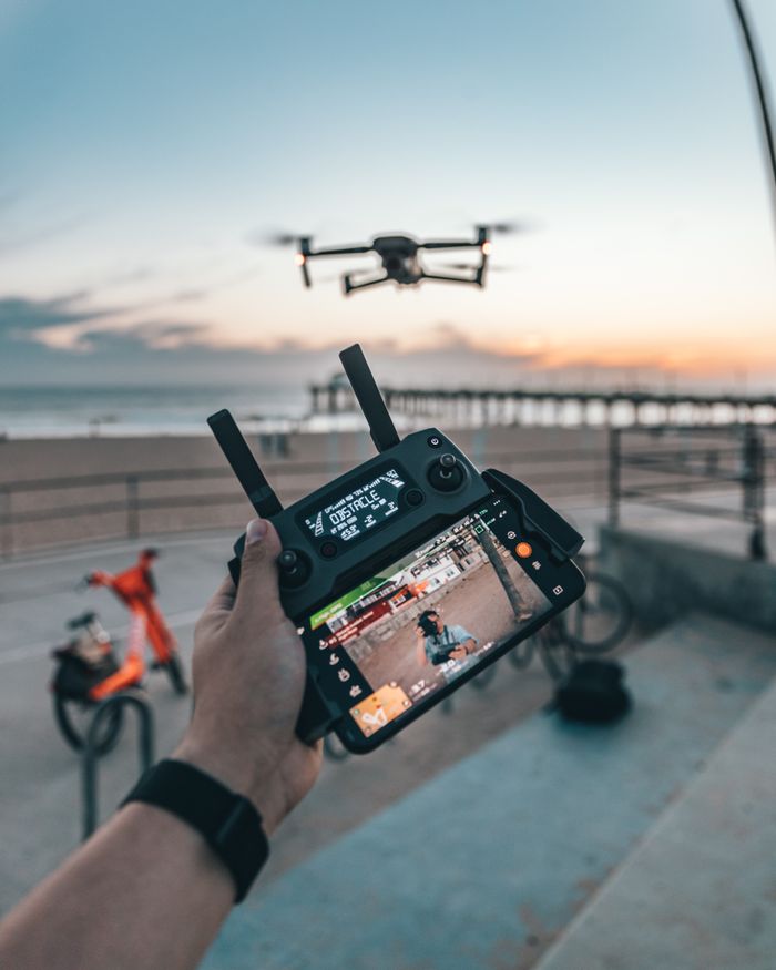 The Art of Drawing Readers In: Your attractive post title goes here Drone piloting at a Los Angeles beach during sunset, capturing vibrant outdoor moments.